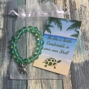 Green Beaded 7 in Elastic Bracelet with Turtle Charm in Organza Bag with Card